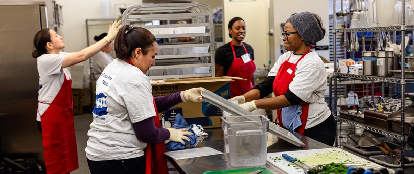 people preparing food in the kitchen