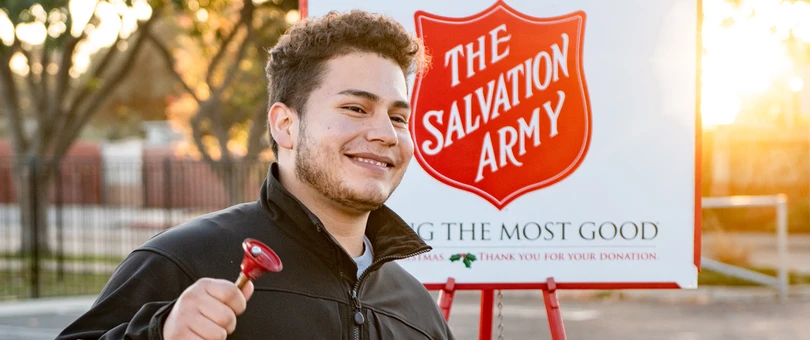 Kid ringing bell for salvation army donations