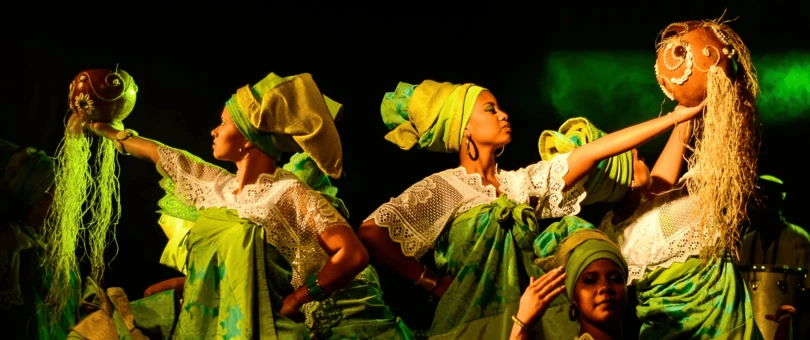 group of women wearing green dresses pn stage